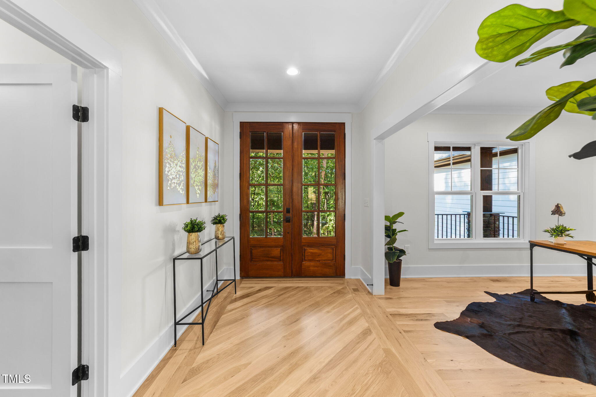 2817 Silk Hope Gum Springs Road Pittsboro, NC 27312 - Photo 6 of 56 a spacious bedroom with a large bed and a window