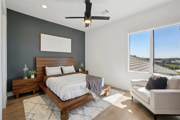 a bedroom with a bed and a chandelier