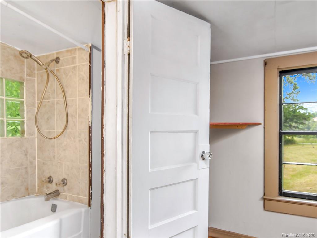 5020 Dutch Cove Road Canton, NC 28716 - Photo 12 of 19 a bathroom with a shower a mirror and a window