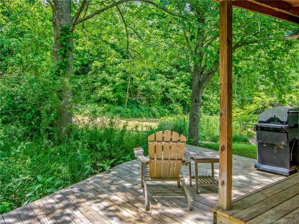 5020 Dutch Cove Road Canton, NC 28716 - Photo 3 of 19 a patio table and chairs with potted plants and large tree