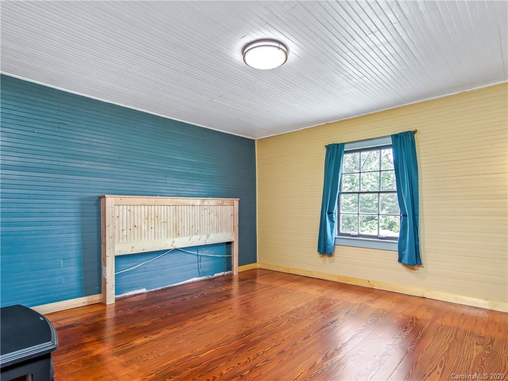 5020 Dutch Cove Road Canton, NC 28716 - Photo 7 of 19 a view of an empty room with wooden floor and a window