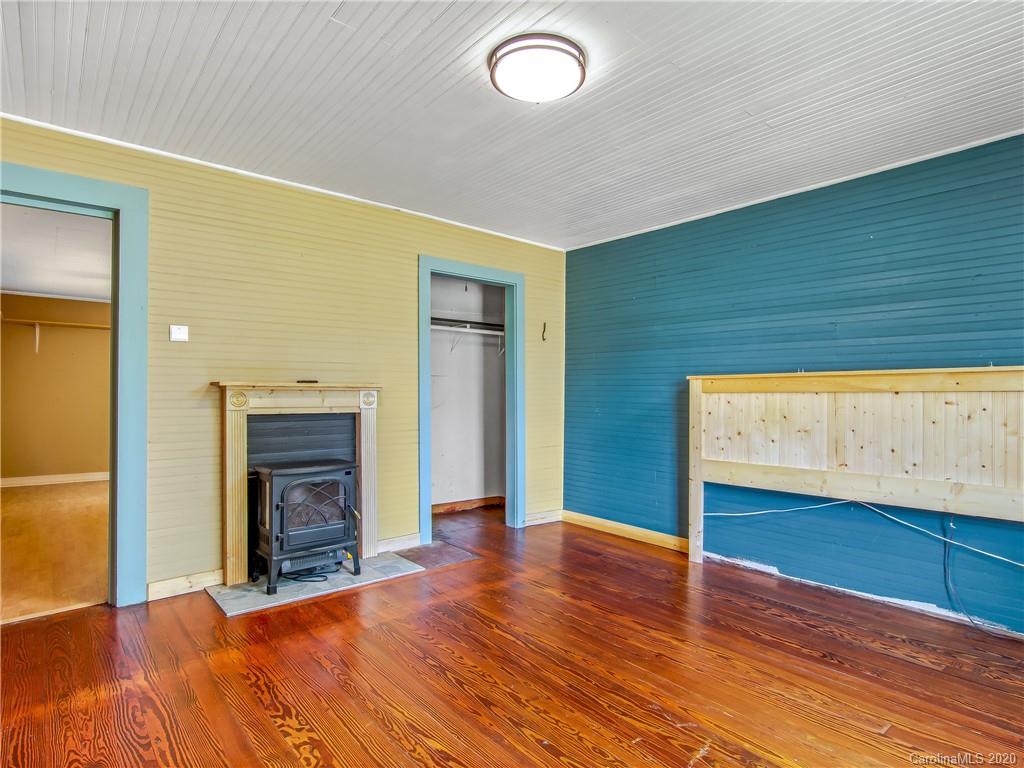 5020 Dutch Cove Road Canton, NC 28716 - Photo 8 of 19 a view of empty room with wooden floor and fireplace
