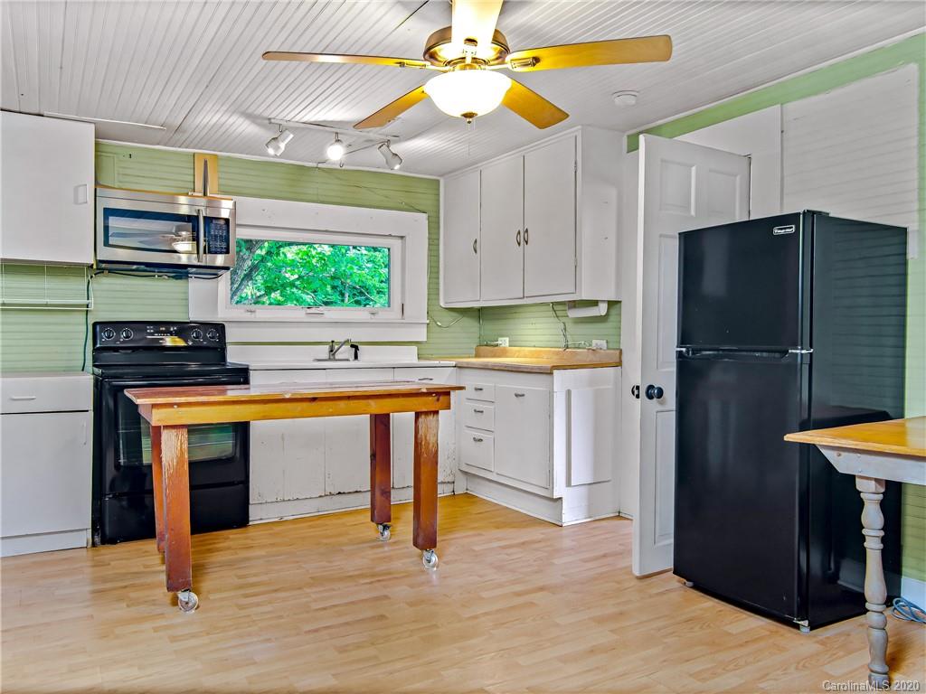 5020 Dutch Cove Road Canton, NC 28716 - Photo 9 of 19 a kitchen with stainless steel appliances a stove refrigerator and cabinets