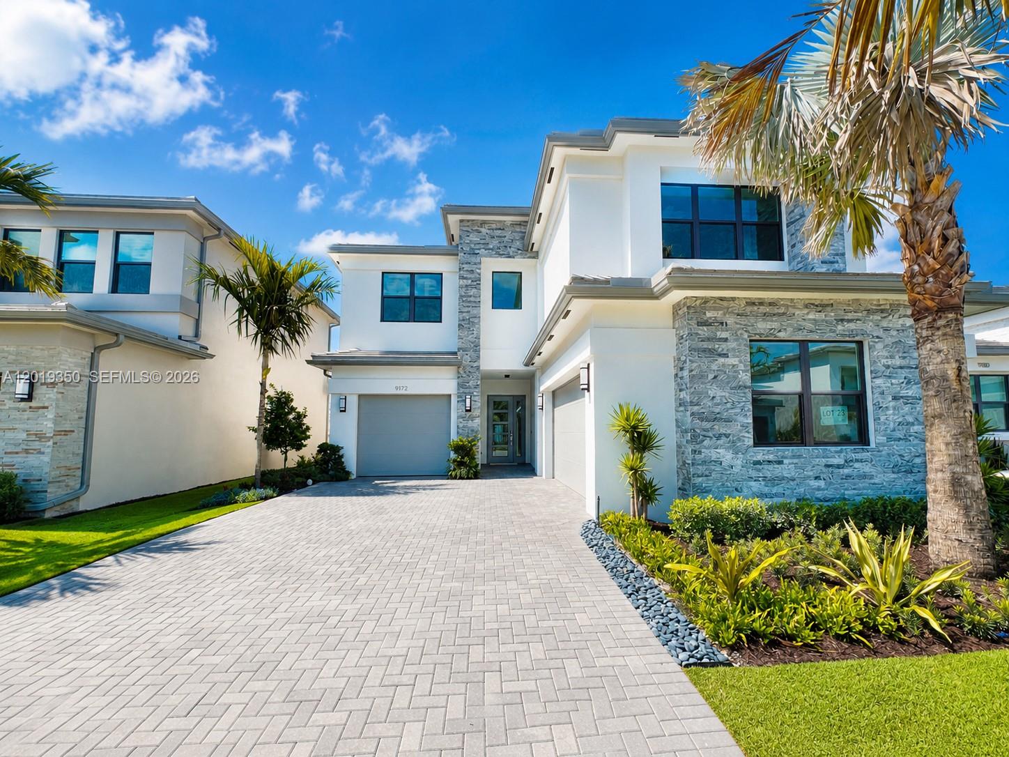 9172 Silver Marsh Lane, Unit 9172 Boca Raton, FL 33434 - Photo 1 of 34 a front view of a house with a garden