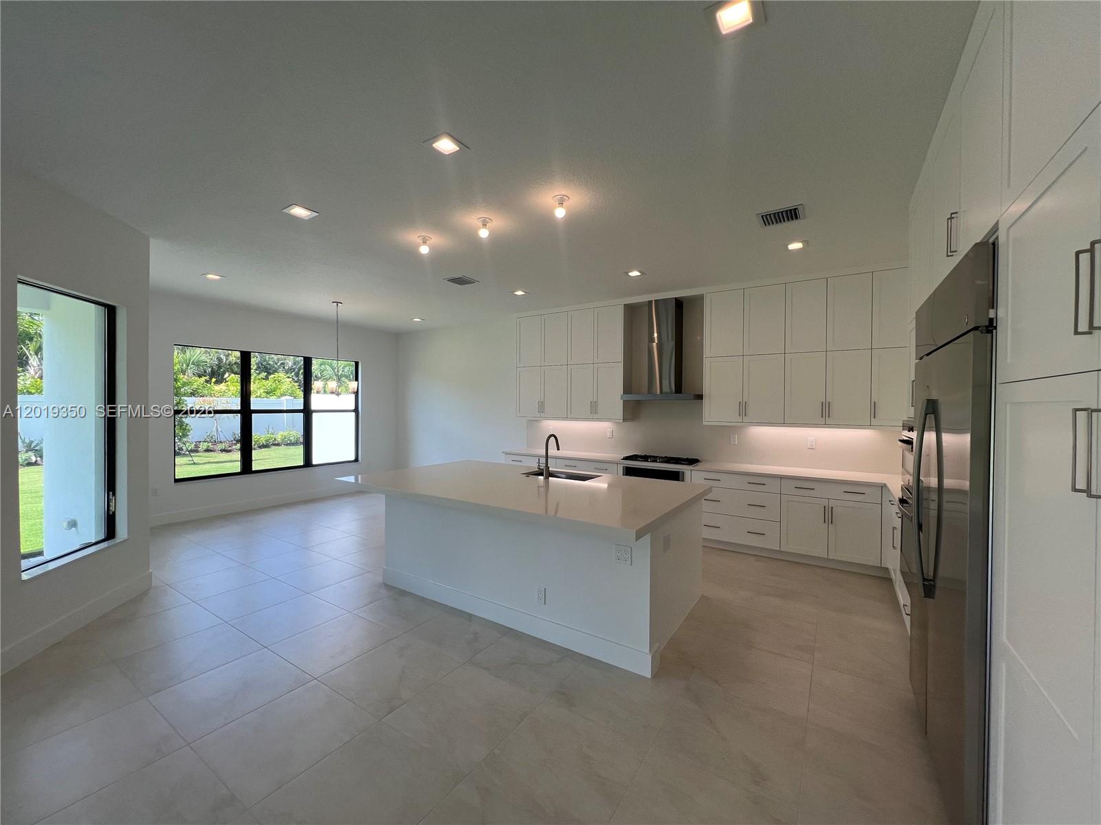 9172 Silver Marsh Lane, Unit 9172 Boca Raton, FL 33434 - Photo 6 of 34 a kitchen with a sink stainless steel appliances furniture cabinets and a window