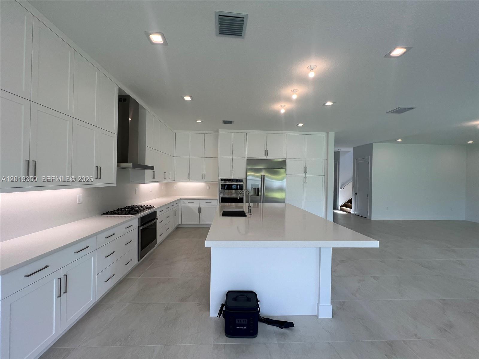 9172 Silver Marsh Lane, Unit 9172 Boca Raton, FL 33434 - Photo 7 of 34 a kitchen with kitchen island a sink stainless steel appliances and cabinets