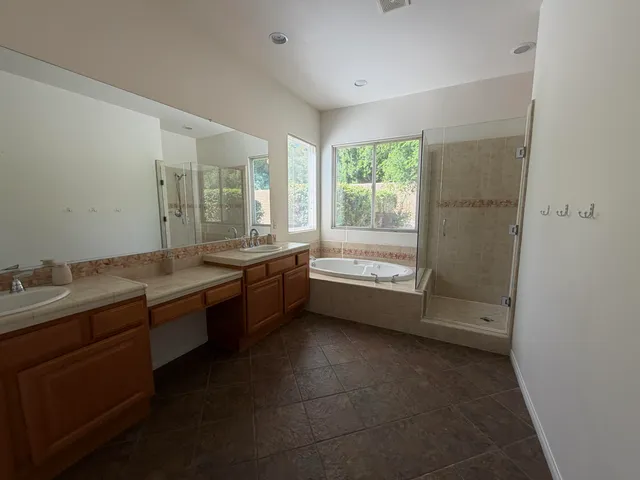 a large bathroom with a large tub and sink