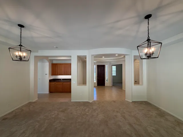 a view of a room with windows and furniture