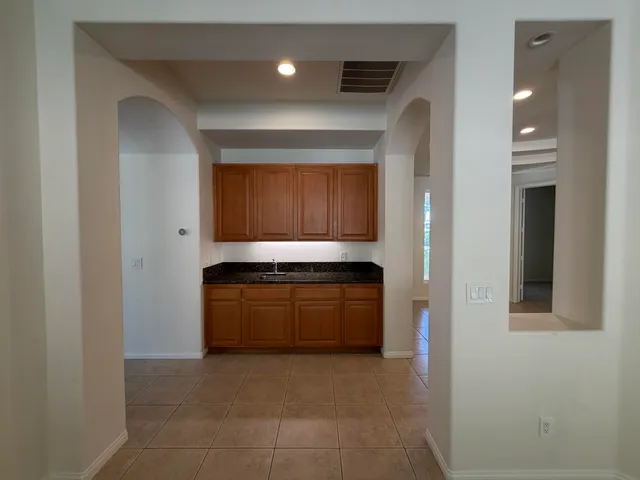a kitchen with granite countertop a stove and a refrigerator