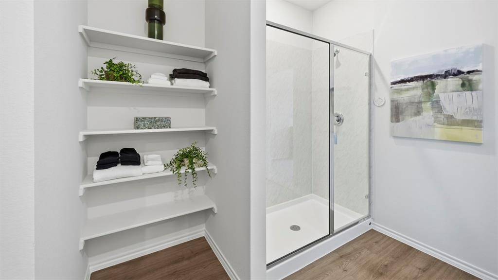 1957 Freeman Street Tyler, TX 75704 - Photo 17 of 25 Shower enclosure featuring a sliding glass door and white shower pan