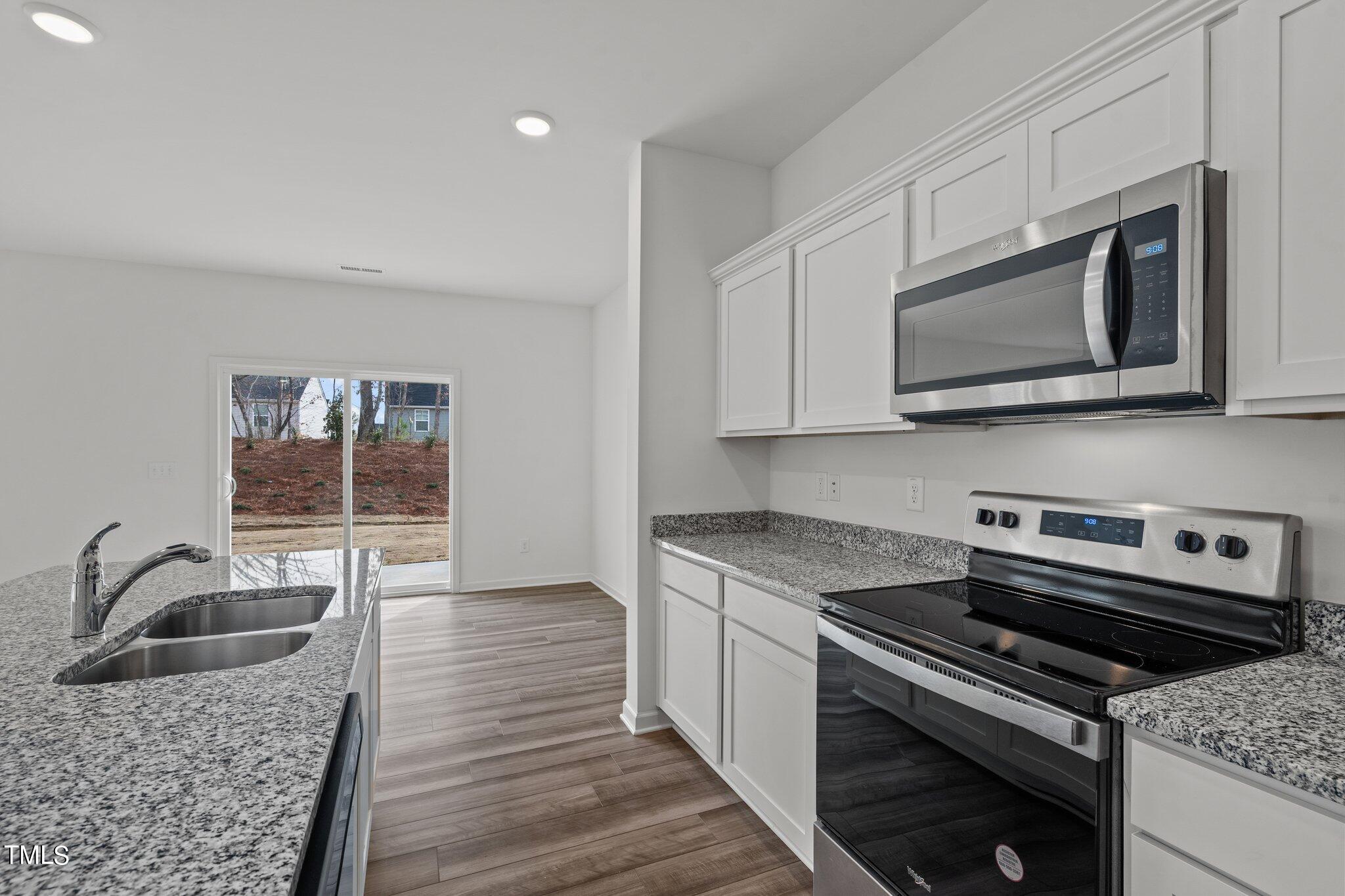 904 Rift Vly Drive Zebulon, NC 27597 - Photo 12 of 43 a kitchen with granite countertop a sink cabinets and stainless steel appliances