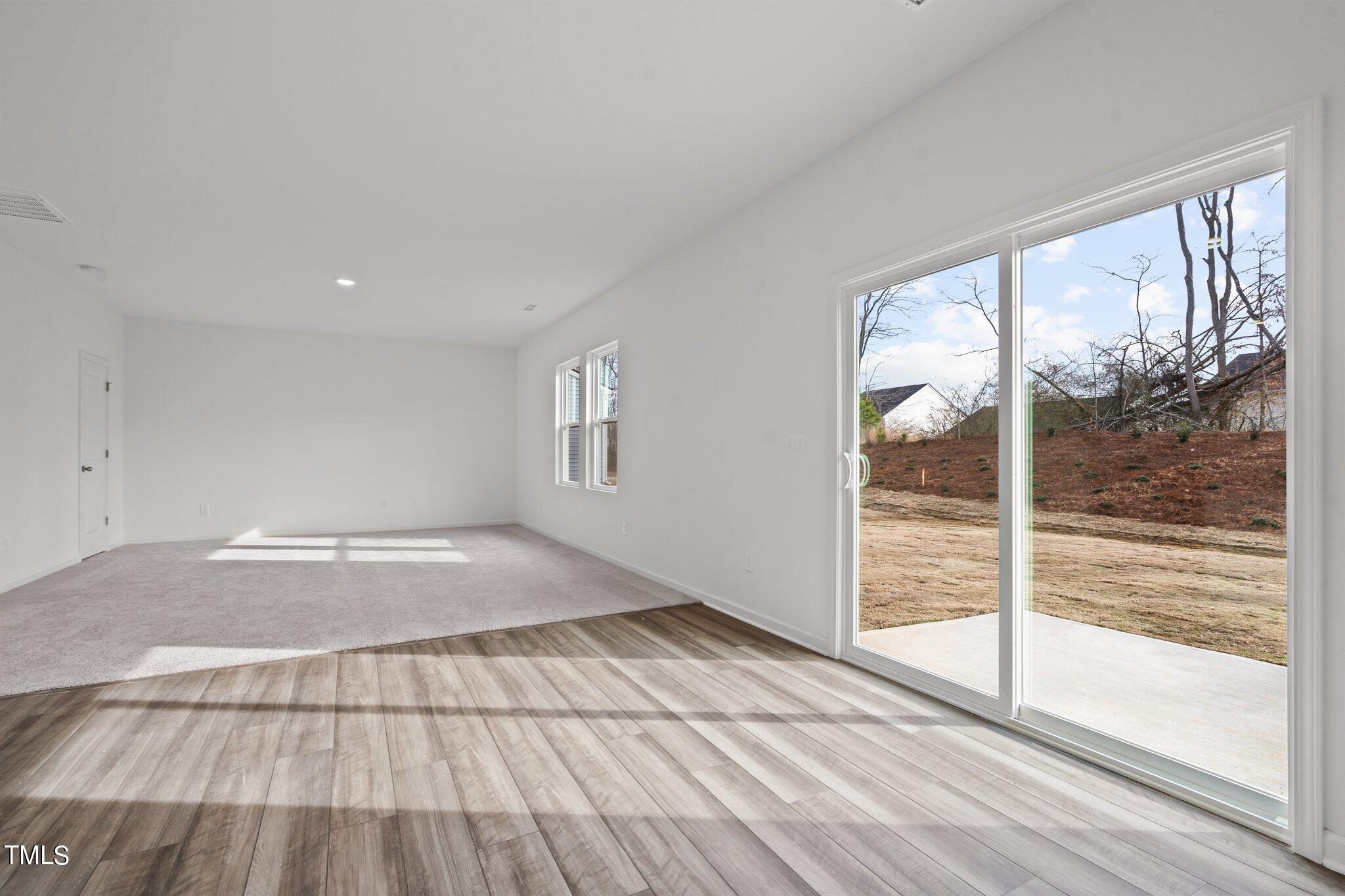 904 Rift Vly Drive Zebulon, NC 27597 - Photo 15 of 43 a view of empty room with wooden floor and fan