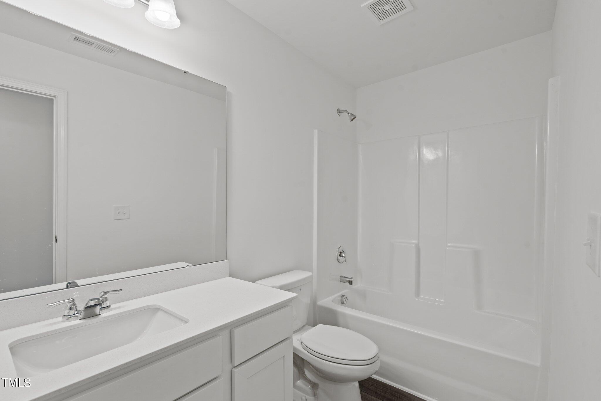 904 Rift Vly Drive Zebulon, NC 27597 - Photo 28 of 43 a bathroom with a sink a toilet and shower