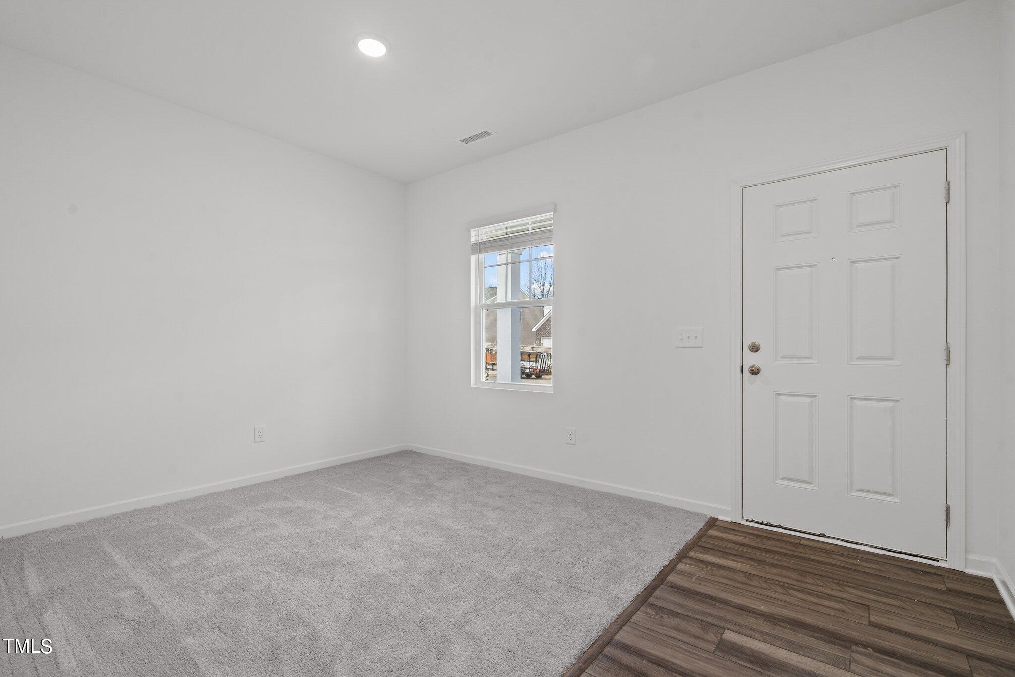 904 Rift Vly Drive Zebulon, NC 27597 - Photo 5 of 43 a view of an empty room with wooden floor and a window