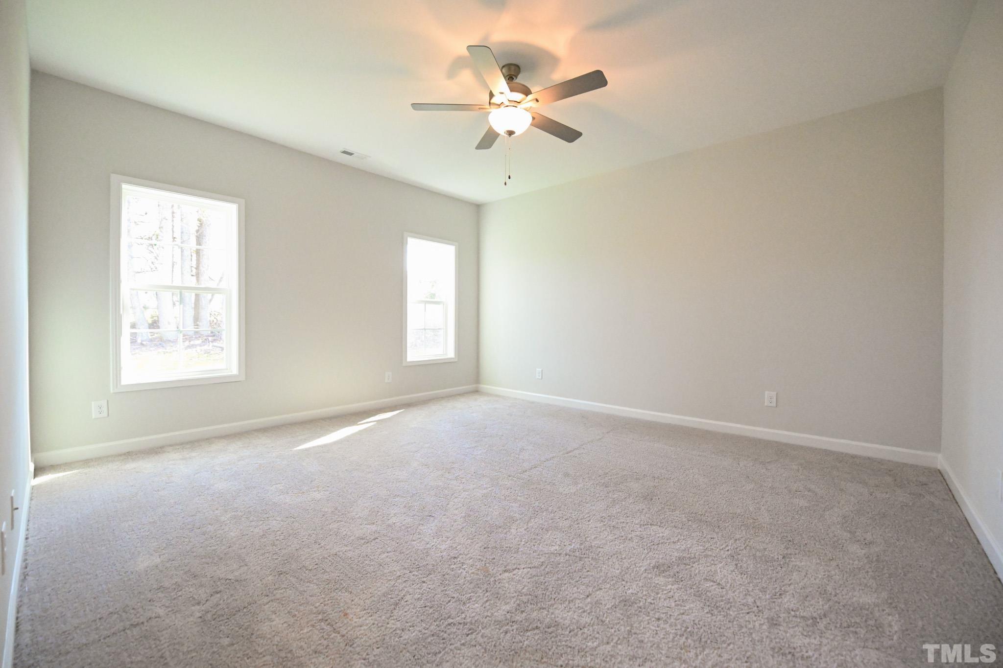 23 Chris Todd Way Angier, NC 27501 - Photo 15 of 28 an empty room with a window and a ceiling fan