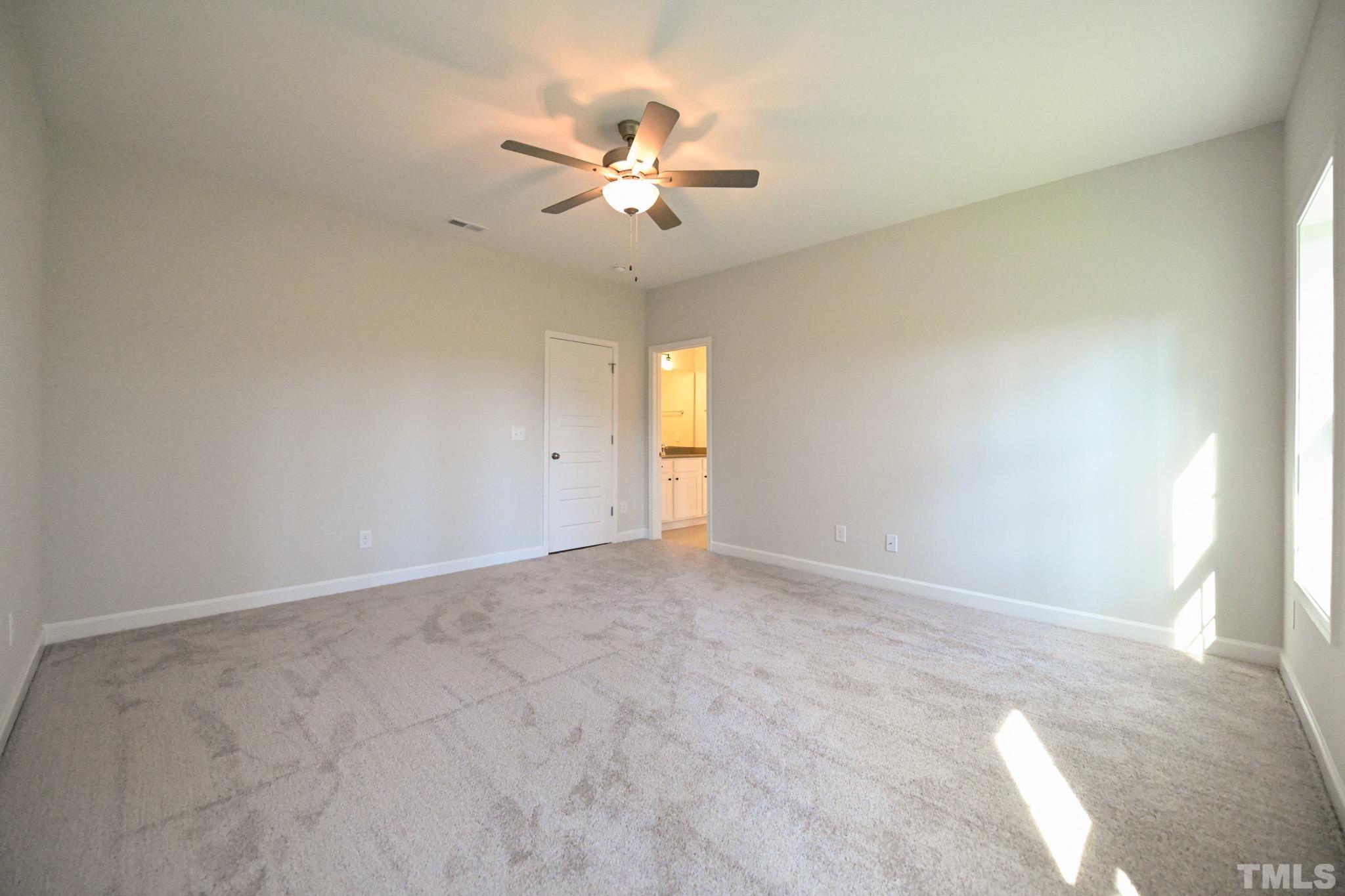 23 Chris Todd Way Angier, NC 27501 - Photo 17 of 28 an empty room with chandelier fan and windows