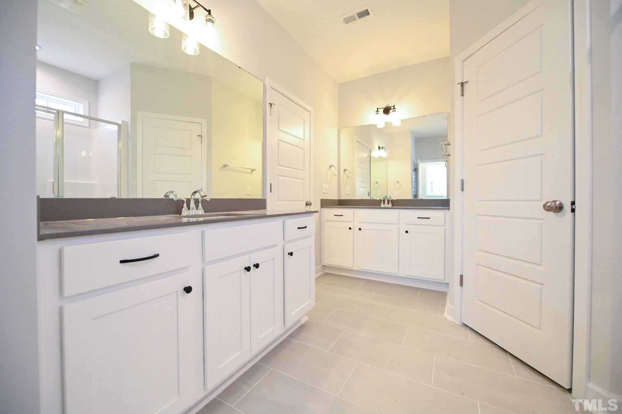 23 Chris Todd Way Angier, NC 27501 - Photo 18 of 28 a bathroom with a sink a mirror and a vanity