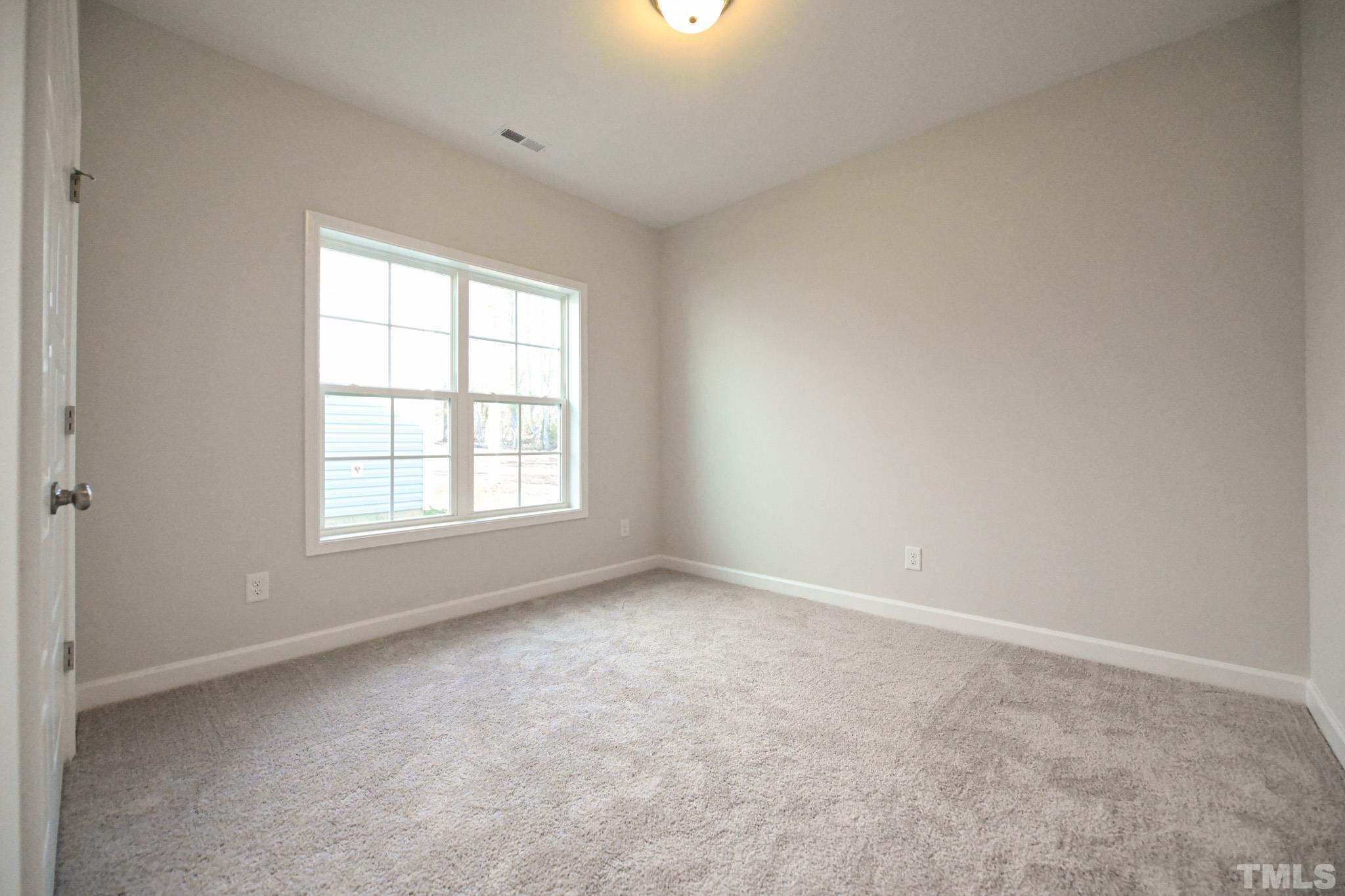 23 Chris Todd Way Angier, NC 27501 - Photo 23 of 28 an empty room with a window