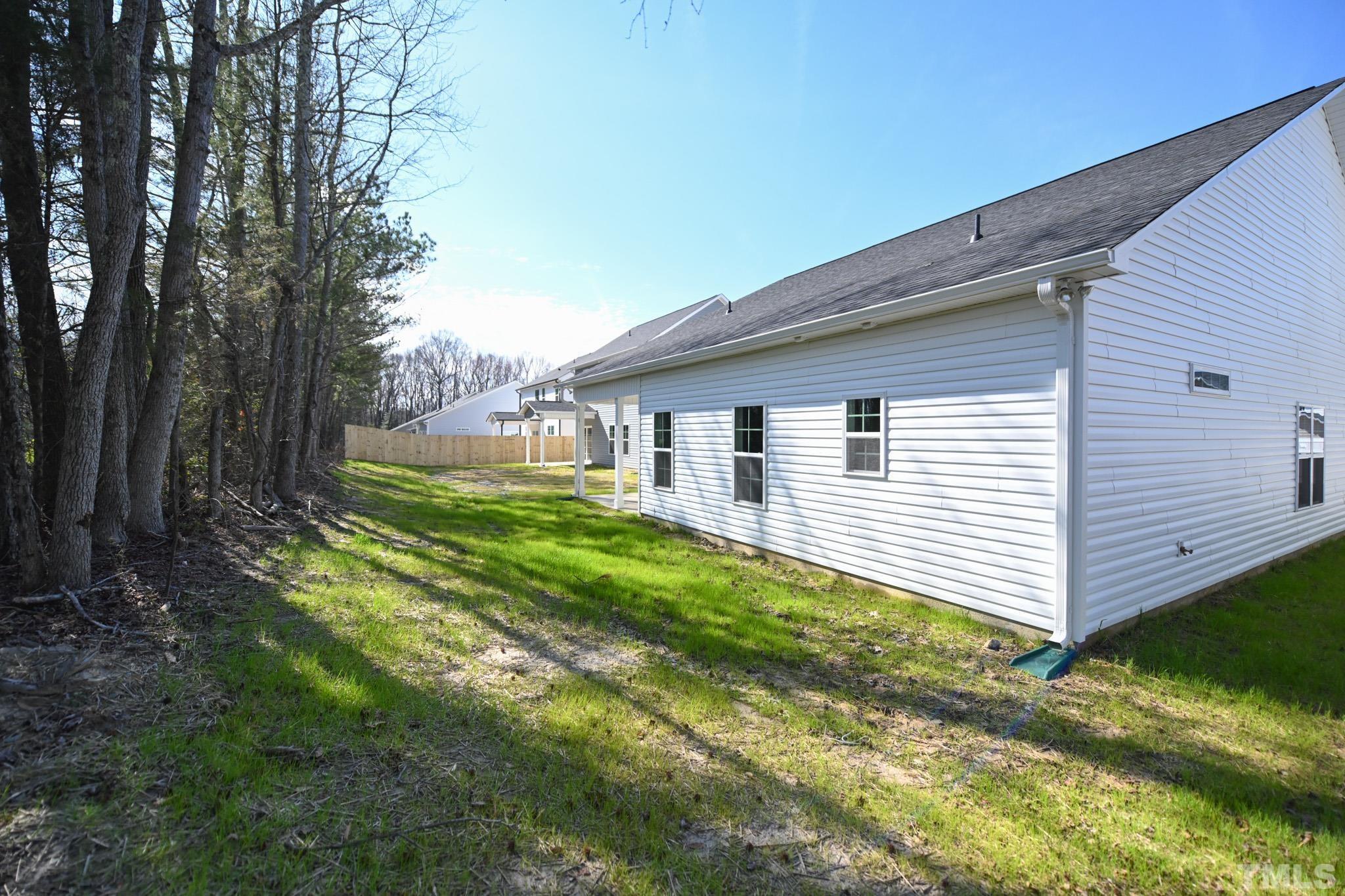 23 Chris Todd Way Angier, NC 27501 - Photo 28 of 28 a view of a backyard with plants and large tree