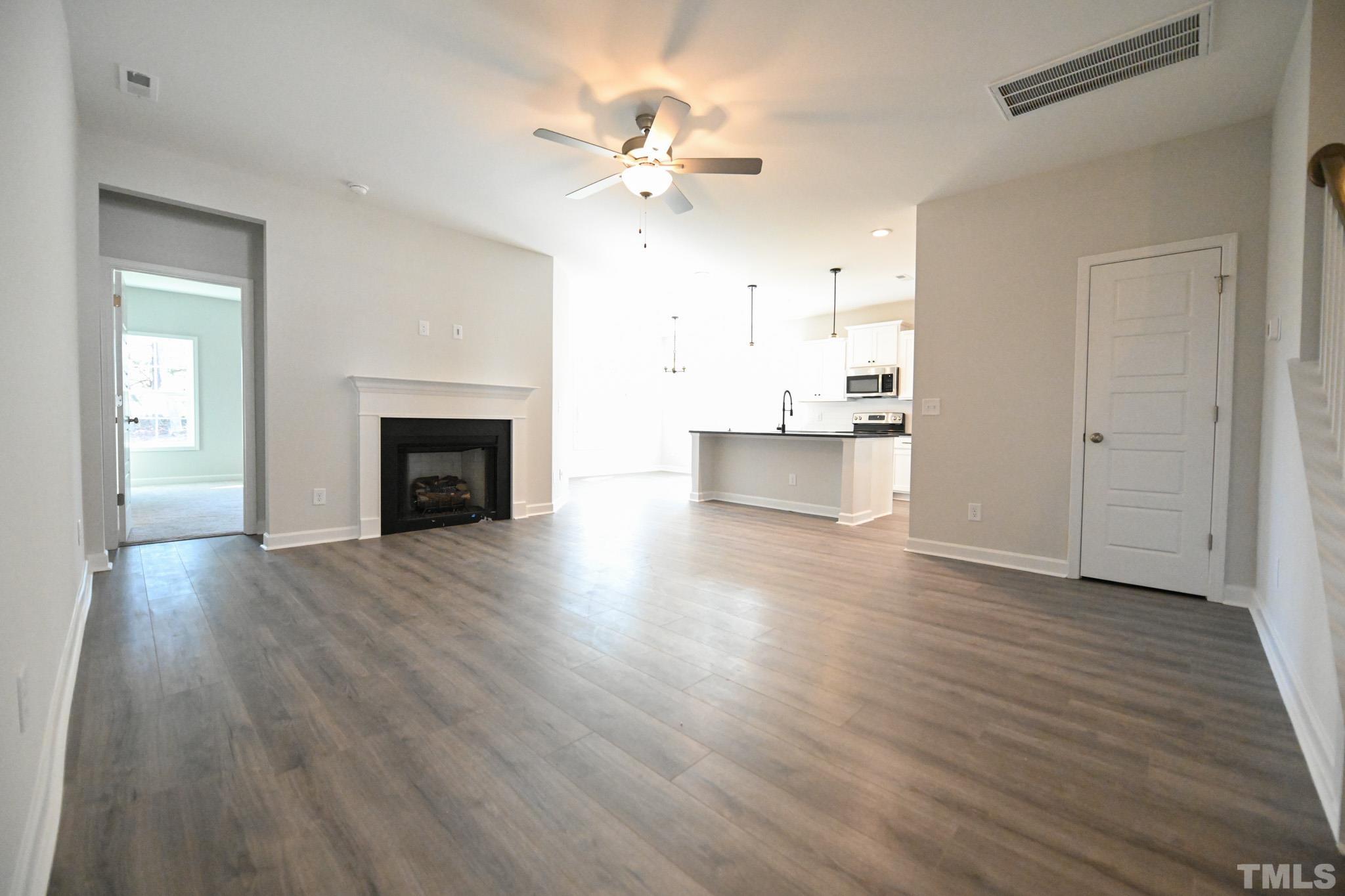 23 Chris Todd Way Angier, NC 27501 - Photo 3 of 28 a view of a kitchen with wooden floor and a kitchen view