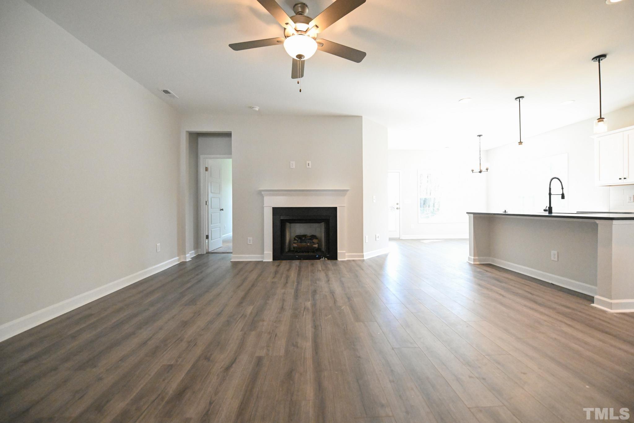 23 Chris Todd Way Angier, NC 27501 - Photo 4 of 28 a view of a livingroom with wooden floor and a ceiling fan