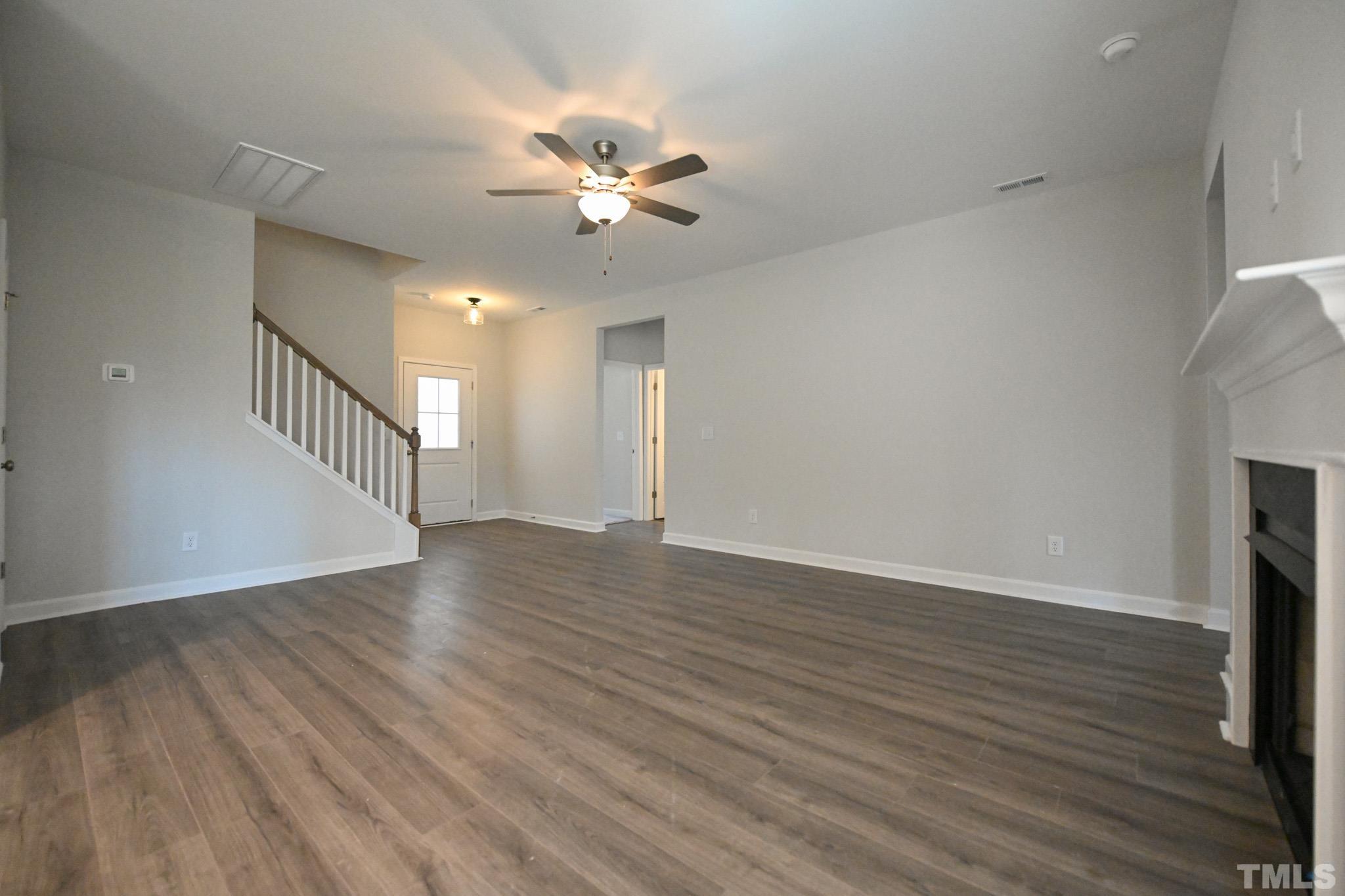 23 Chris Todd Way Angier, NC 27501 - Photo 6 of 28 a view of an empty room with wooden floor and a chandelier fan