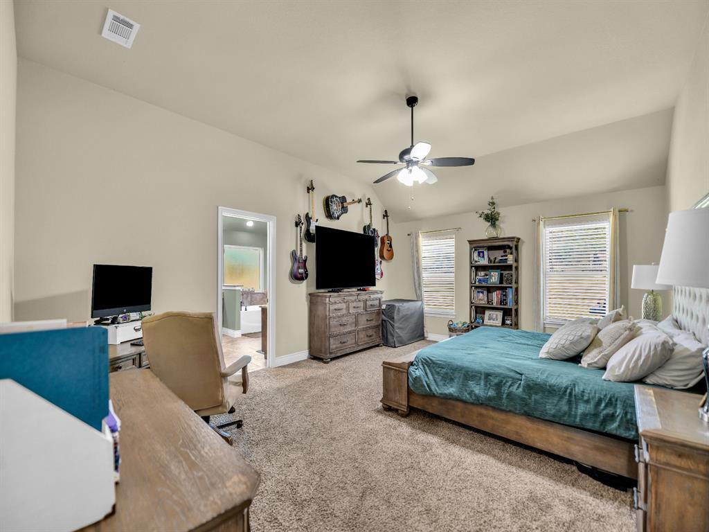 156 Cottongame Road Weatherford, TX 76088 - Photo 15 of 35 a bedroom with a bed and a flat screen tv