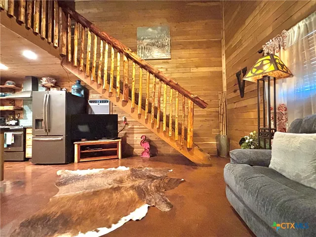 a living room with furniture windows and a flat screen tv