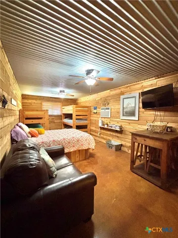 a bedroom with two beds and a couch