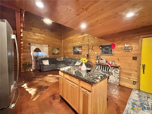 a view of a patio with table and chairs