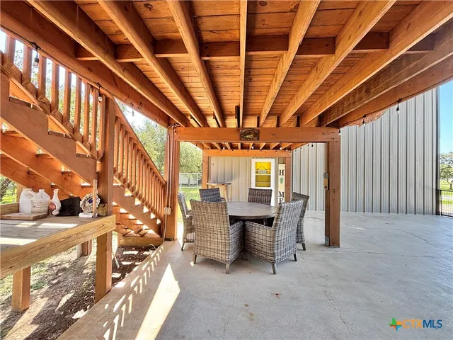 a view of a livingroom with furniture and staircase