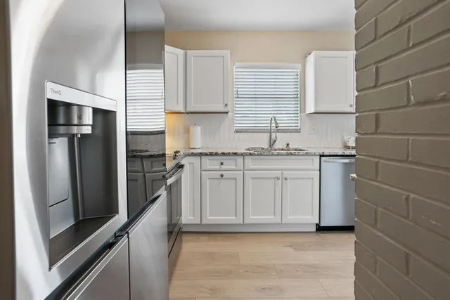 a kitchen with a sink stove and refrigerator