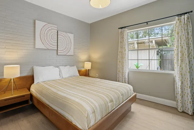 a bedroom with a large bed and a window