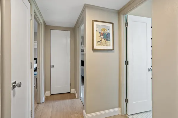 a view of a hallway with wooden floor