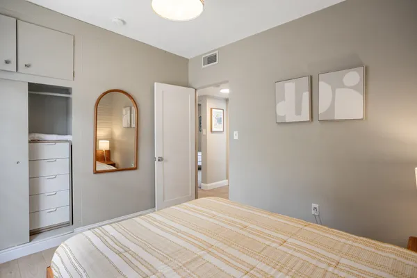 a bedroom with a bed and a bathroom