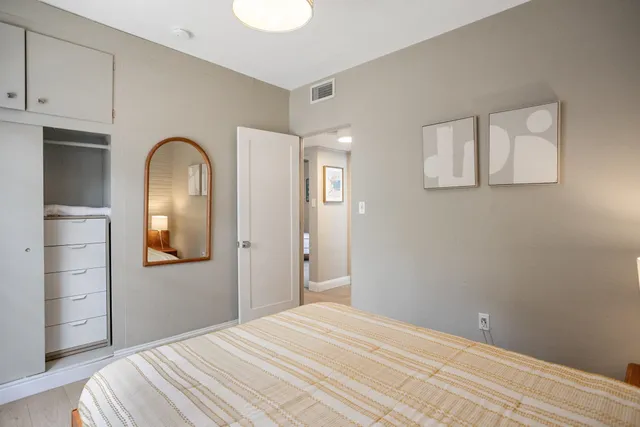 a bedroom with a bed and a bathroom