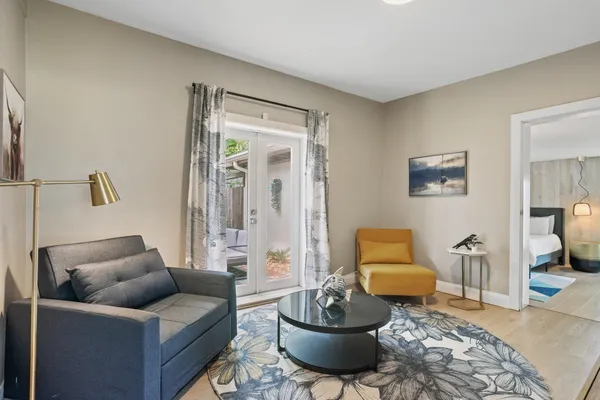 a living room with furniture and a wooden floor