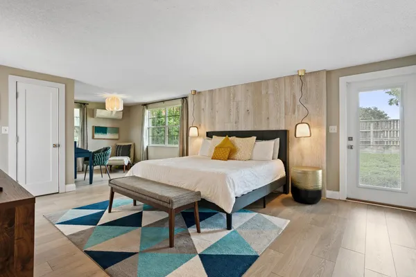 a bedroom with a bed a table and chair