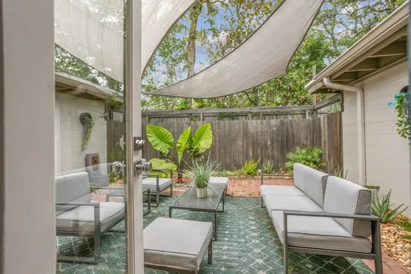 a view of a patio with table and chairs potted plants with wooden floor