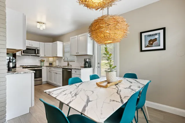 a kitchen with a table chairs and a refrigerator