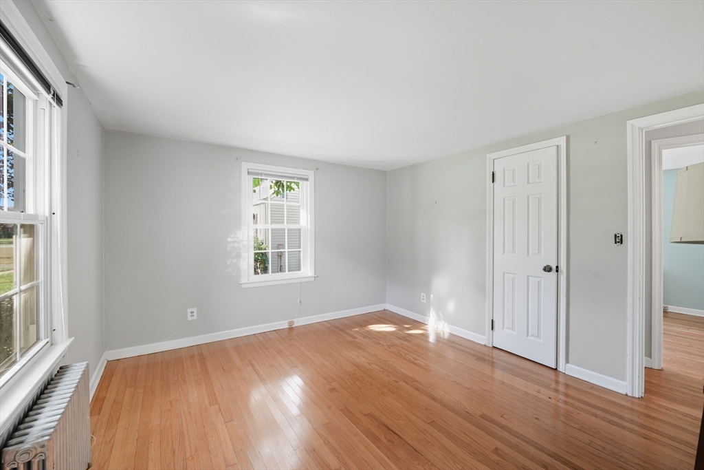 1636 Longmeadow Street Longmeadow, MA 01106 - Photo 18 of 33 a view of an empty room with wooden floor and a window