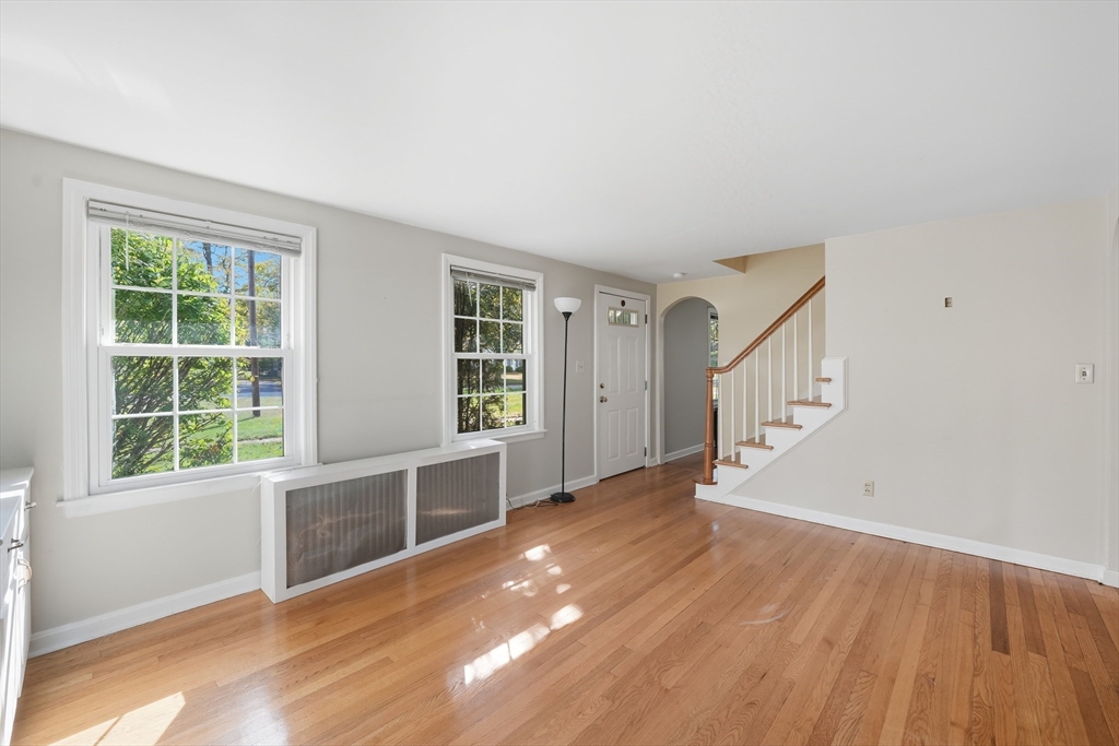 1636 Longmeadow Street Longmeadow, MA 01106 - Photo 7 of 33 a view of an empty room with wooden floor and a window