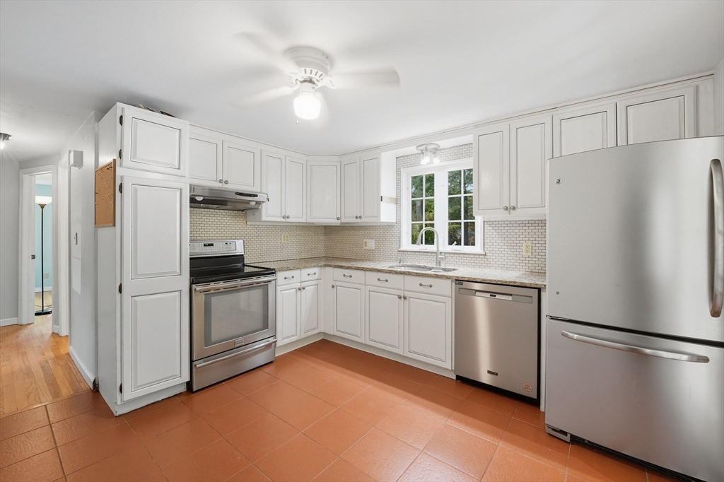 1636 Longmeadow Street Longmeadow, MA 01106 - Photo 9 of 33 a kitchen with stainless steel appliances a refrigerator sink and microwave