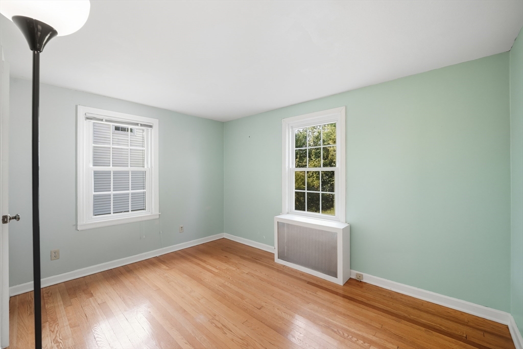 1636 Longmeadow Street Longmeadow, MA 01106 - Photo 10 of 33 an empty room with wooden floor and windows