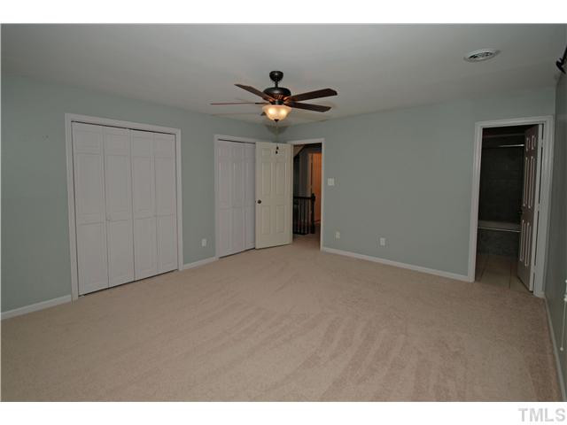 8304 Heel Stone Court Raleigh, NC 27613 - Photo 13 of 25 Enjoy the wooded views from the Master bedroom that features double closets with built in shelving and a ceiling fan. Master Bedroom