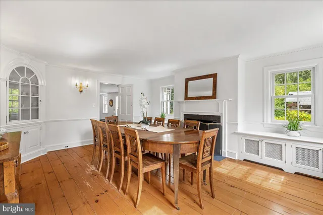 a view of a dining room with furniture and a chandelier