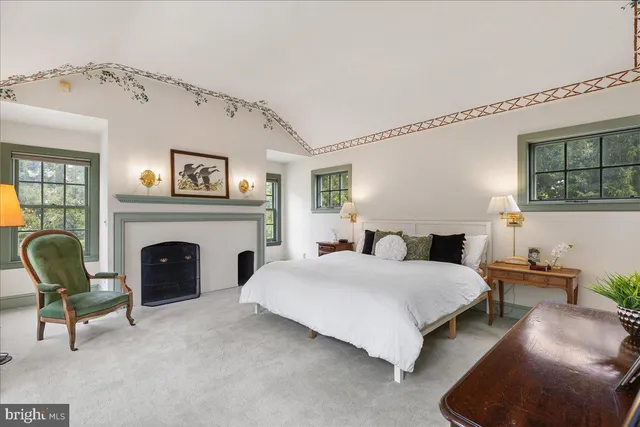 a bedroom with a bed and dresser with mirror