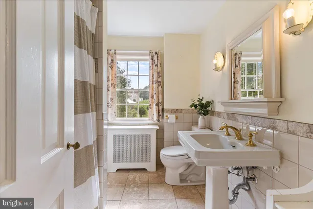 a view of a house with a patio and a yard