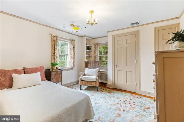 a view of a large pool with an outdoor space and seating area