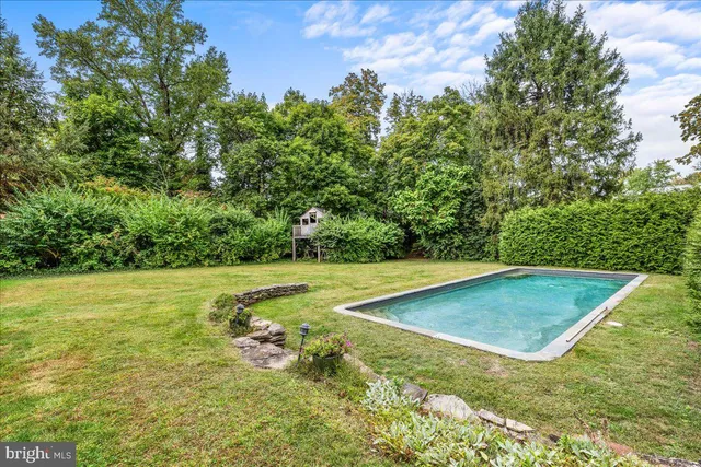 an aerial view of a house with a yard basket ball court and outdoor seating